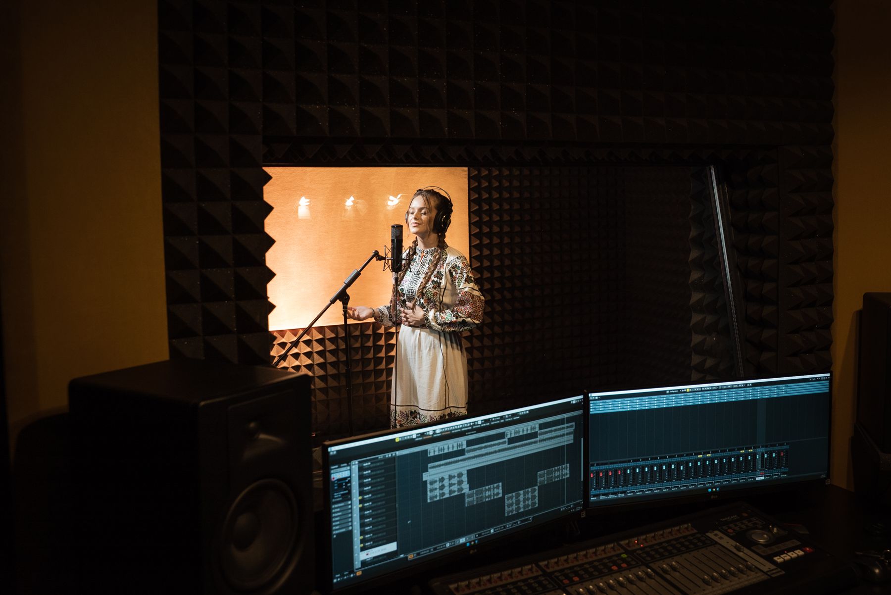 A singer recording in the Moara cu Sunet studio, seen from the control room